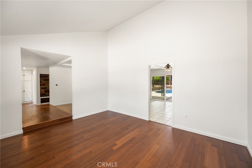 16481 Valle Vista Way Riverside, CA 92506 - Photo 21 of 73 an empty room with wooden floor and natural light