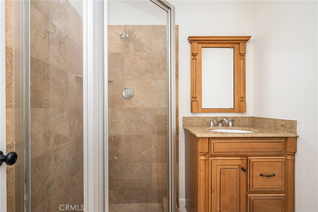 16481 Valle Vista Way Riverside, CA 92506 - Photo 23 of 73 a bathroom with a sink a vanity and a mirror