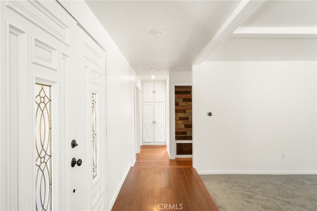 16481 Valle Vista Way Riverside, CA 92506 - Photo 25 of 73 a view of a hallway with wooden floor and closet