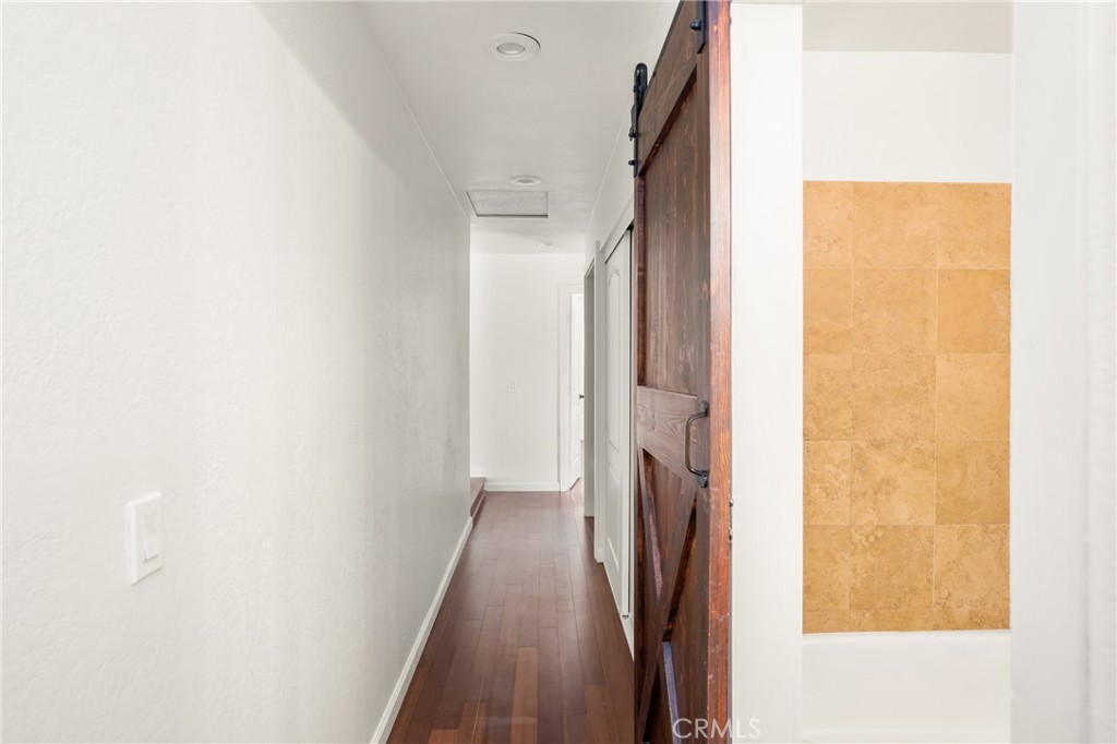 16481 Valle Vista Way Riverside, CA 92506 - Photo 27 of 73 a view of a hallway with wooden floor and staircase