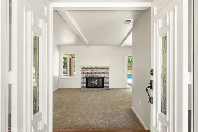an empty room with furniture and fireplace