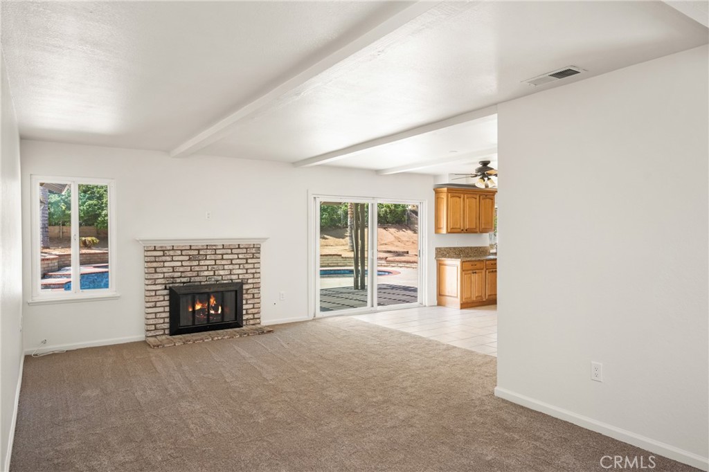 16481 Valle Vista Way Riverside, CA 92506 - Photo 9 of 73 an empty room with furniture and fireplace