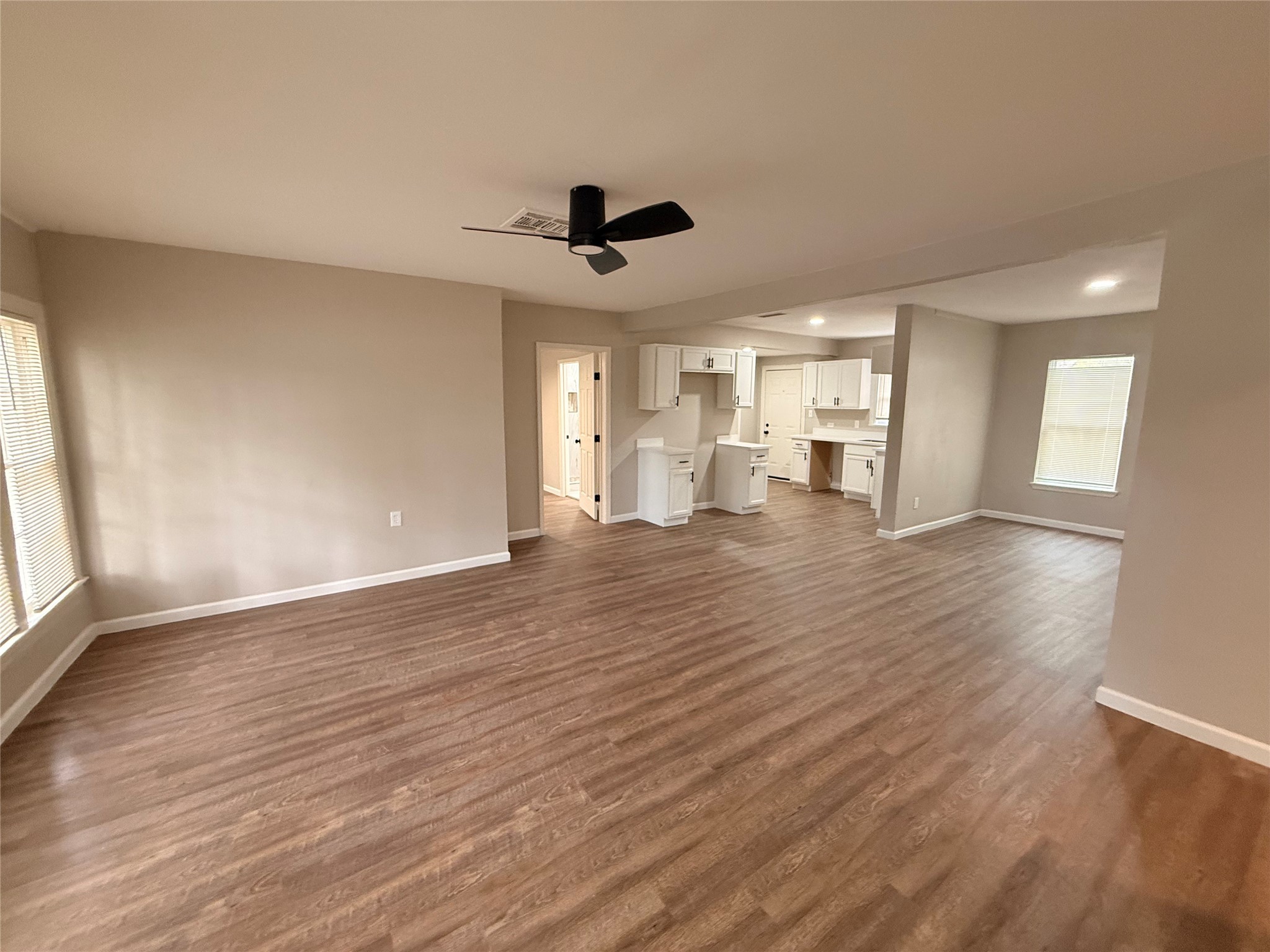 6633 Burkett Street Houston, TX 77021 - Photo 3 of 13 a view of an empty room with window and wooden floor