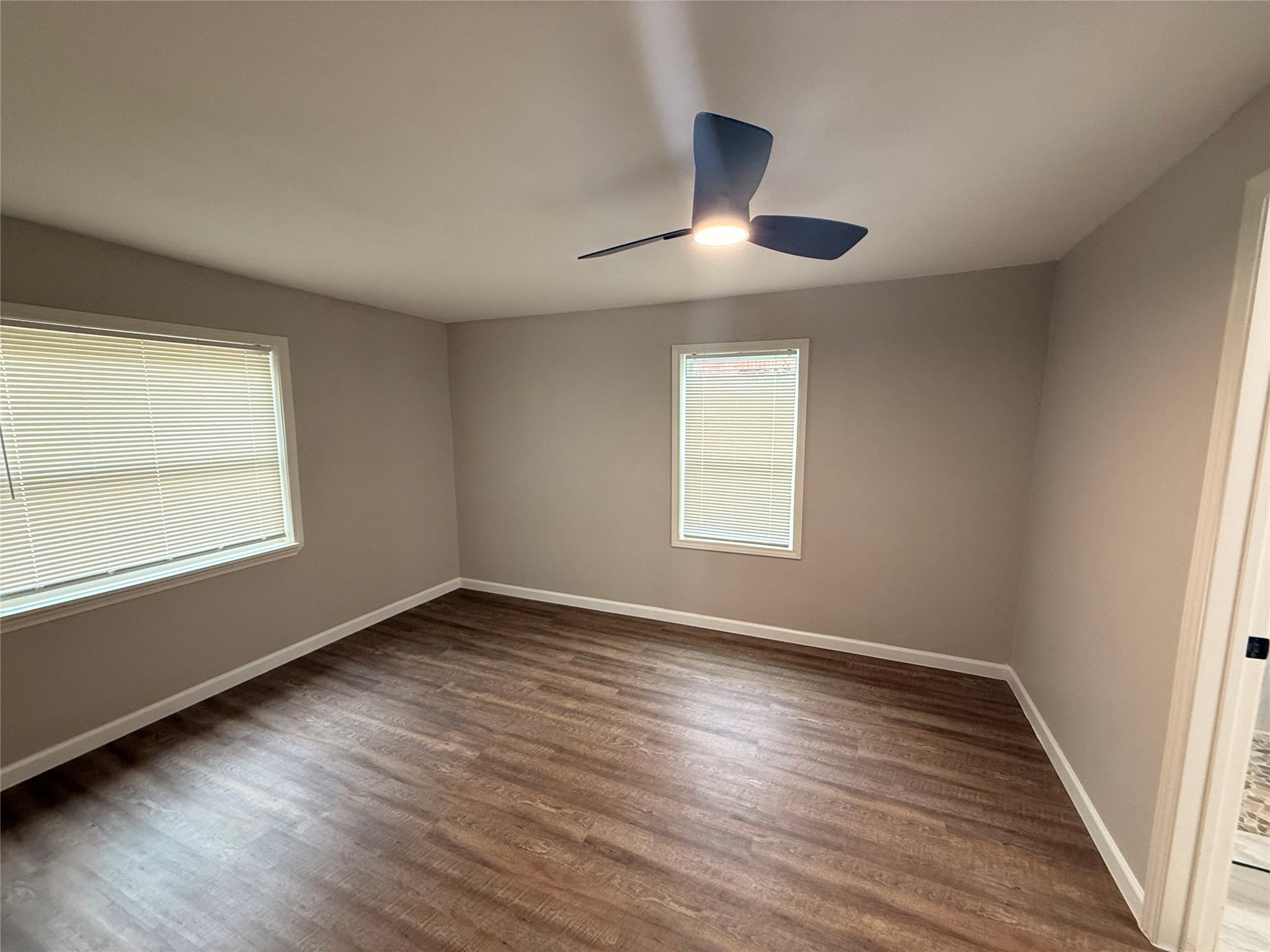 6633 Burkett Street Houston, TX 77021 - Photo 6 of 13 an empty room with wooden floor and windows