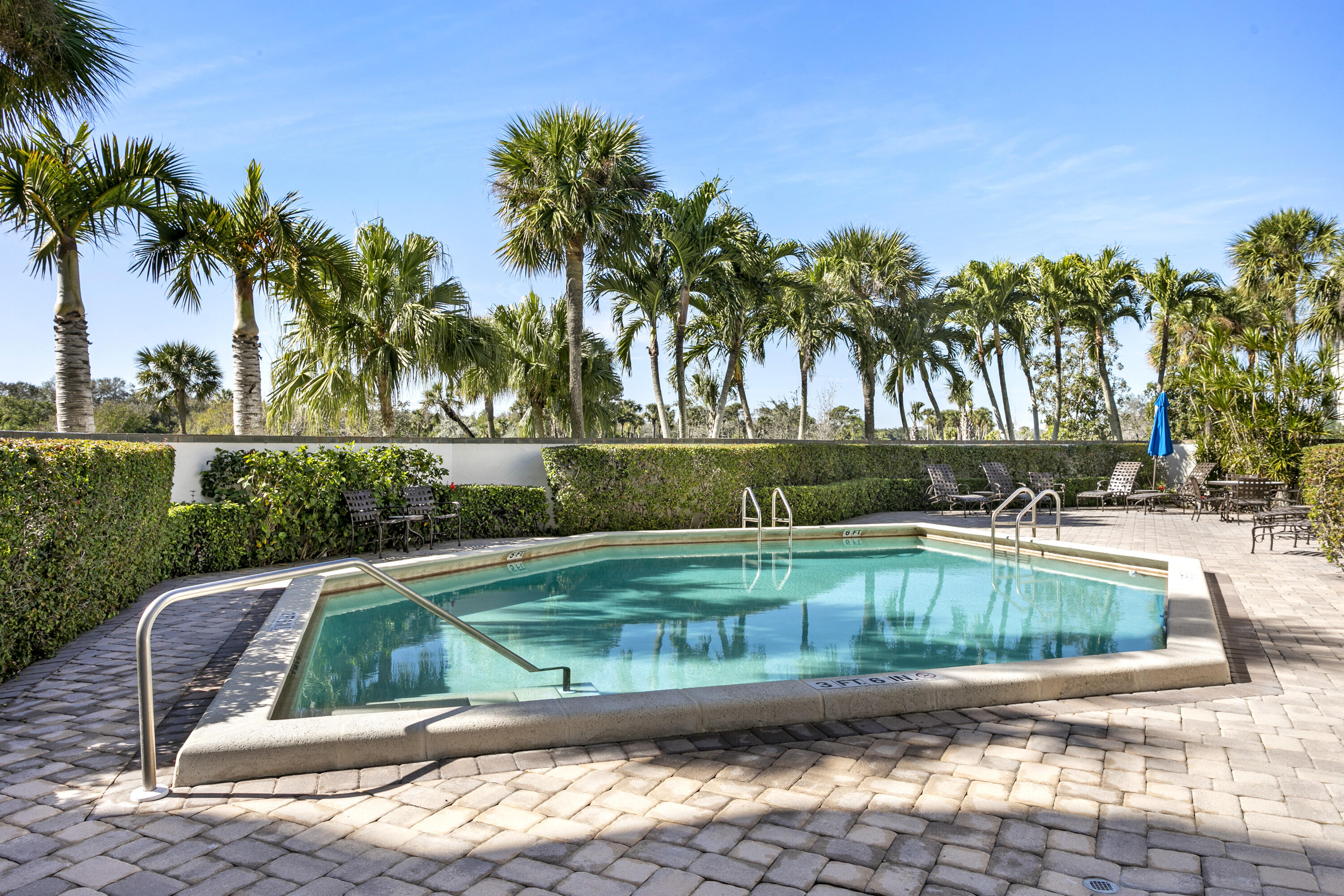 3322 Casseekey Island Road, Unit 504 Jupiter, FL 33477 - Photo 38 of 46 a view of a swimming pool with a lounge chair