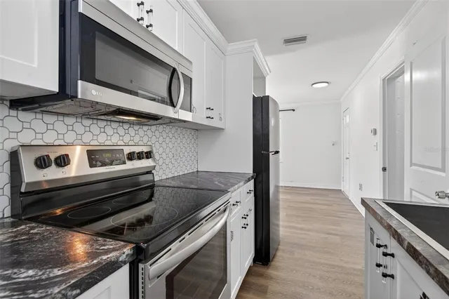 a kitchen with a stove and a microwave
