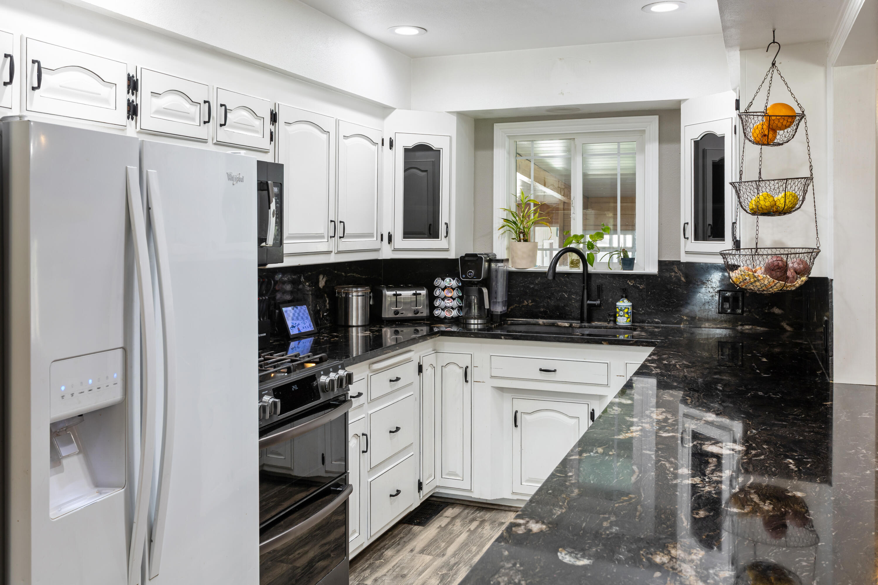 8641 Redbank Road Redding, CA 96001 - Photo 14 of 59 a kitchen with stainless steel appliances a refrigerator a stove and a sink
