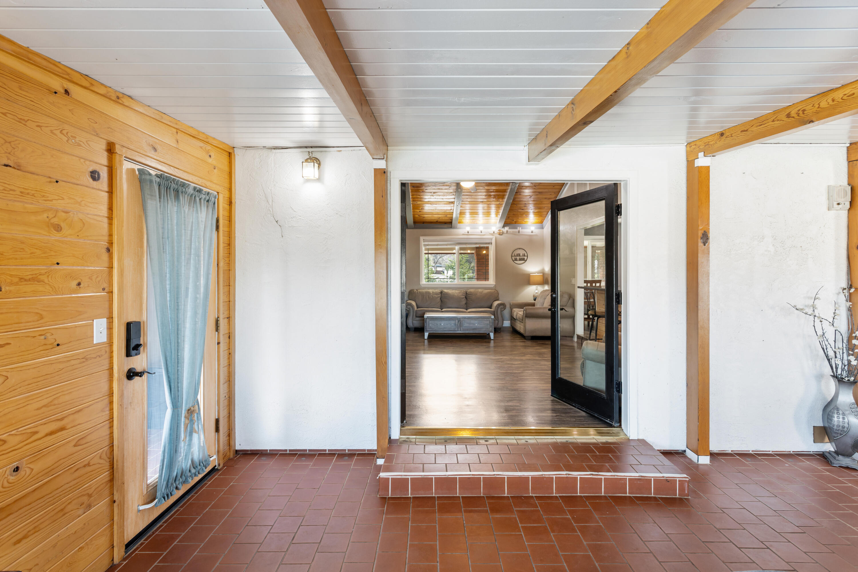 8641 Redbank Road Redding, CA 96001 - Photo 22 of 59 a view of a hallway with living room and wooden floor
