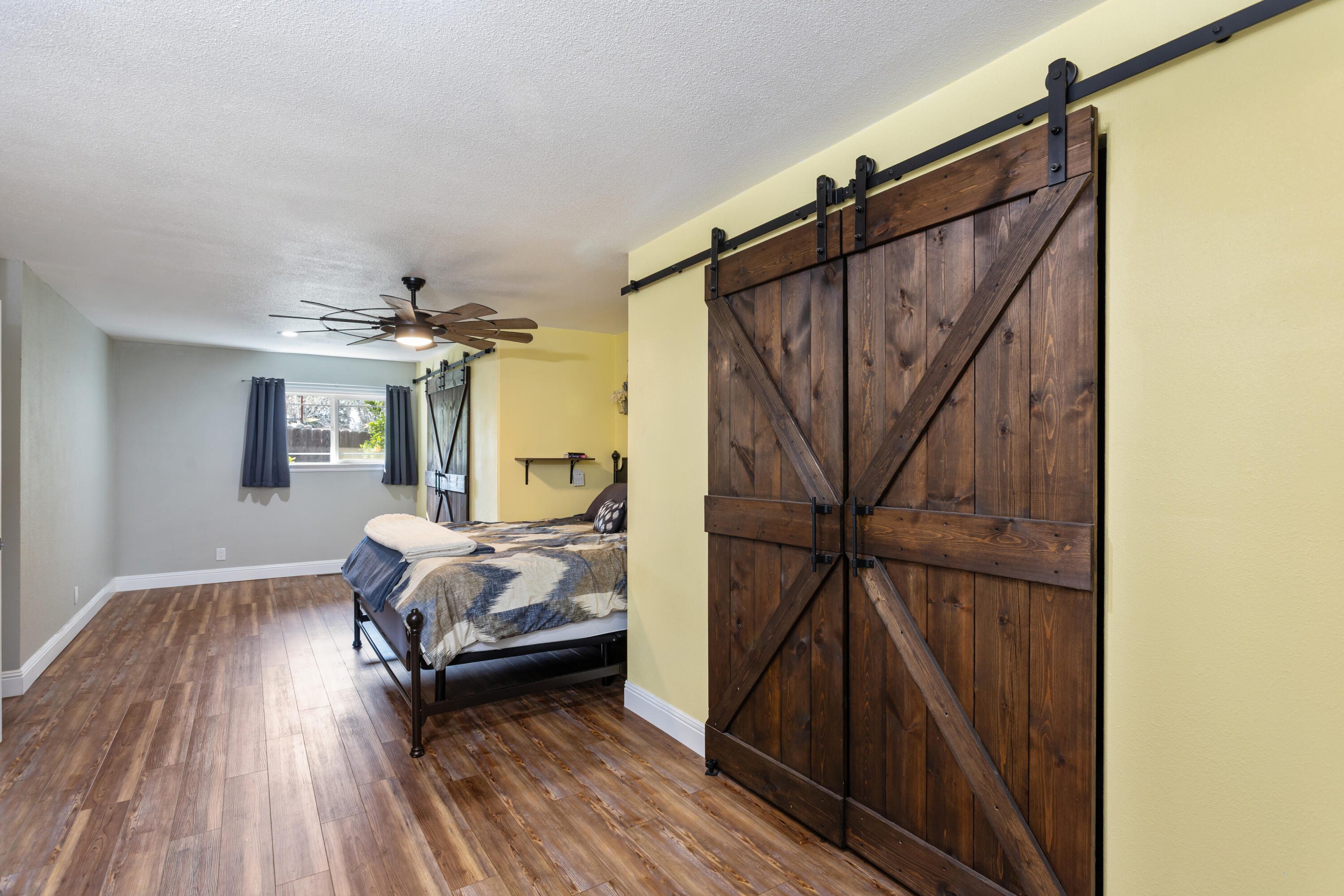 8641 Redbank Road Redding, CA 96001 - Photo 23 of 59 a bedroom with a bed and wooden floor