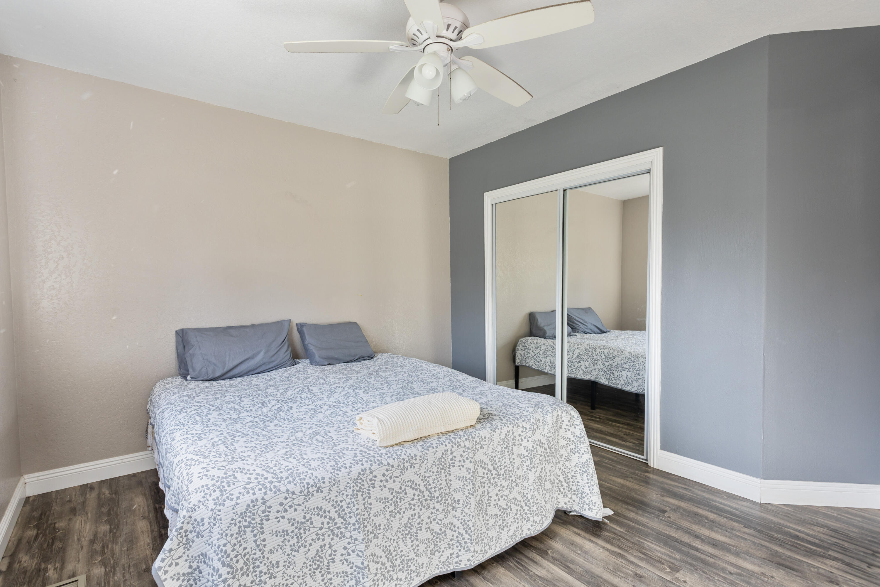 8641 Redbank Road Redding, CA 96001 - Photo 30 of 59 a bedroom with a bed and wooden floor