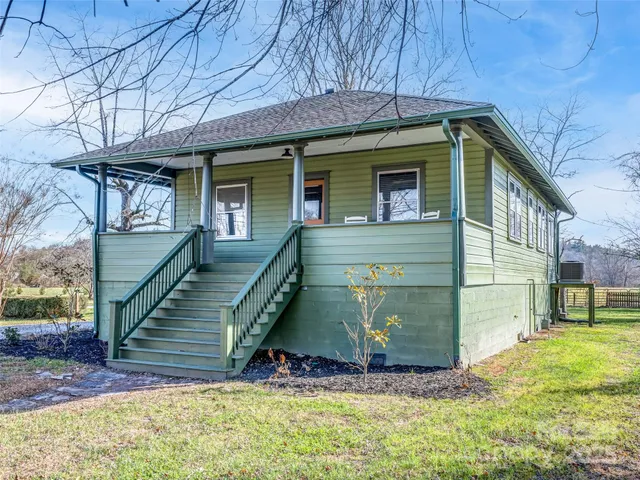 a view of a house with wooden fence