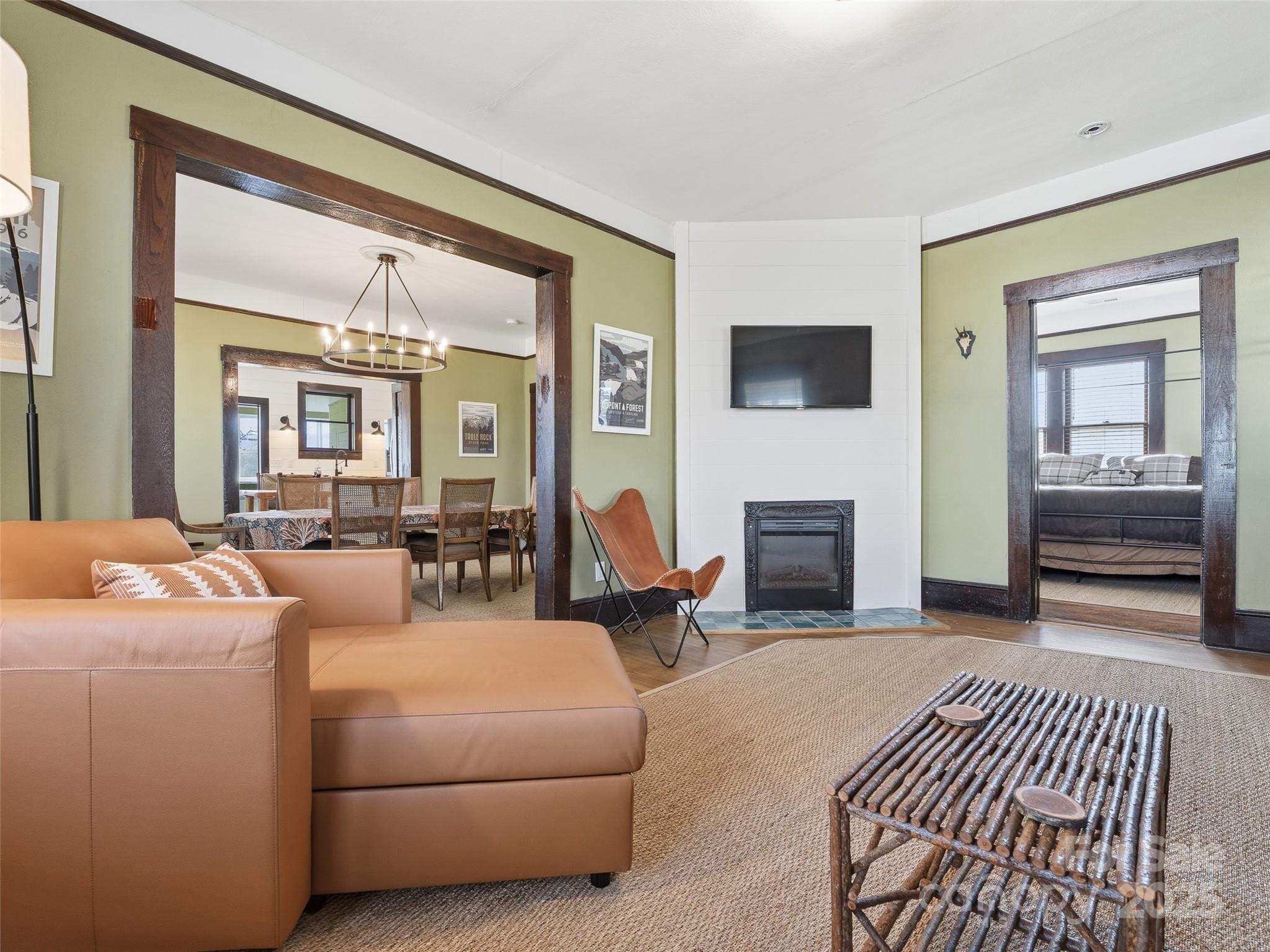 12 Sal's Lane Brevard, NC 28712 - Photo 8 of 39 a living room with furniture a flat screen tv and a fireplace