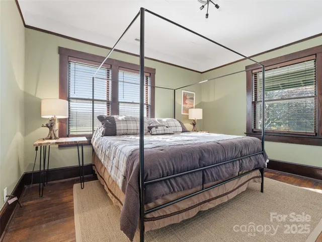 a bedroom with a bed next to a window