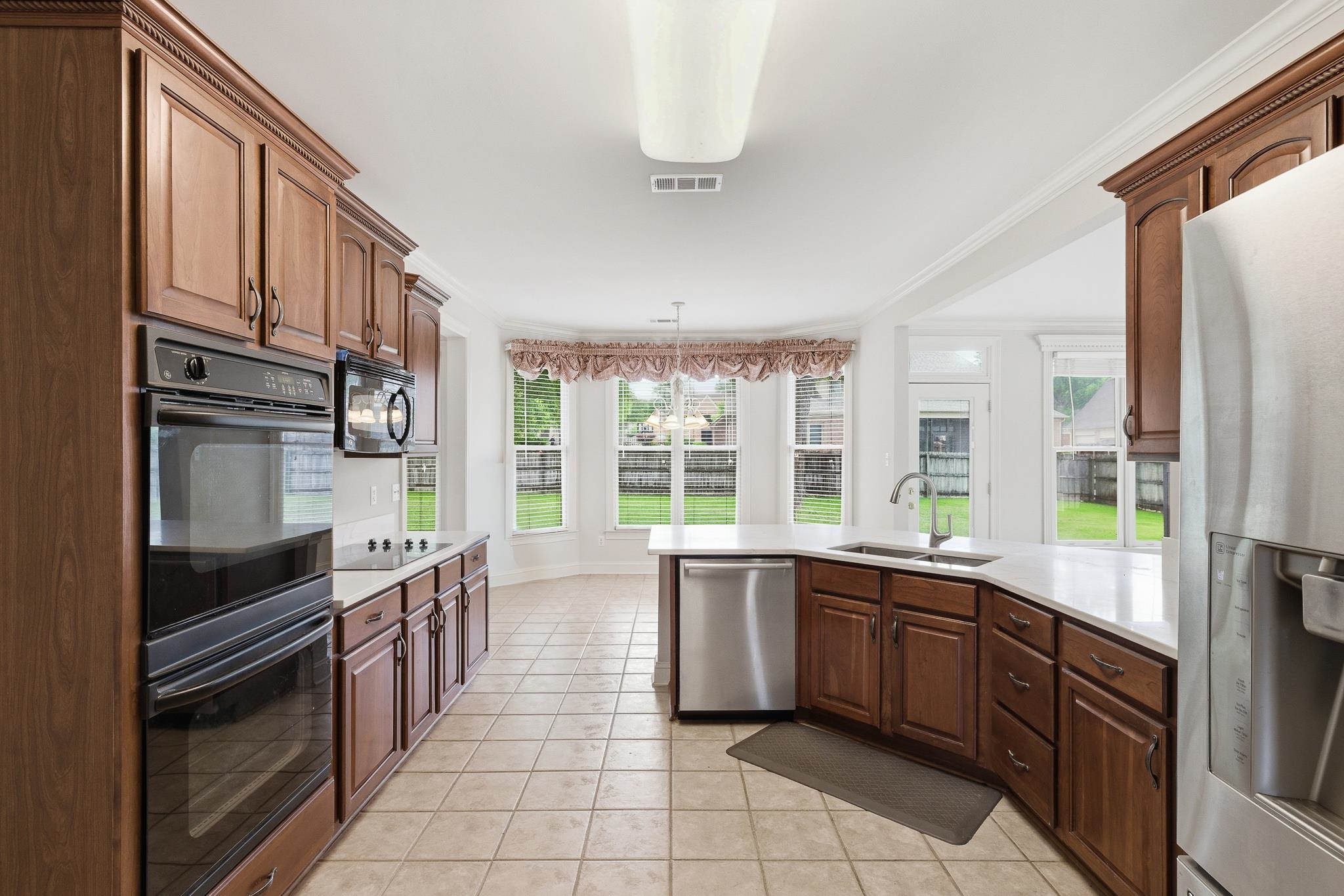 1348 Colbert Cove Collierville, TN 38017 - Photo 15 of 34 a kitchen with stainless steel appliances a sink stove and cabinets