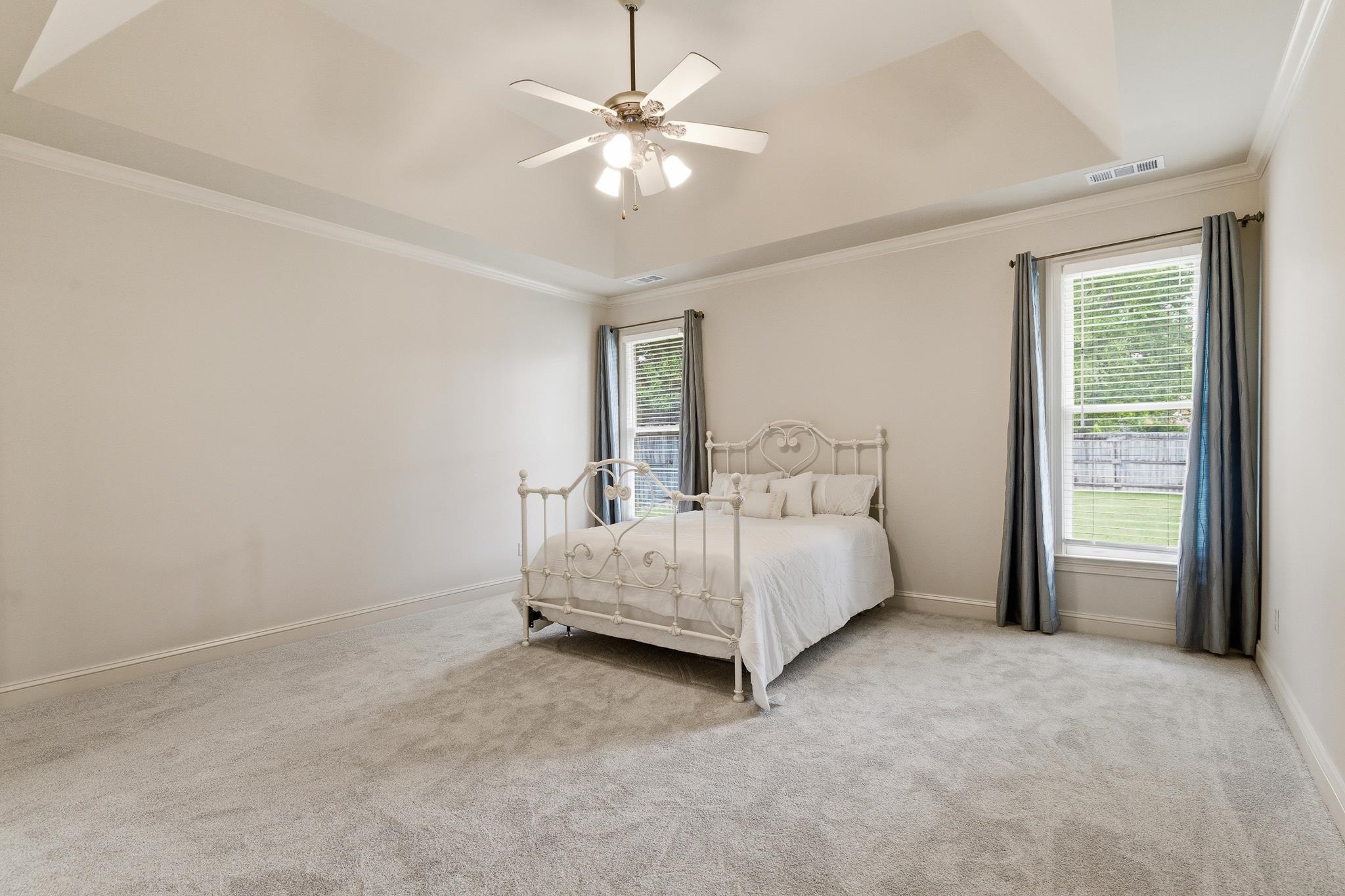 1348 Colbert Cove Collierville, TN 38017 - Photo 16 of 34 a spacious bedroom with a bed and a chandelier