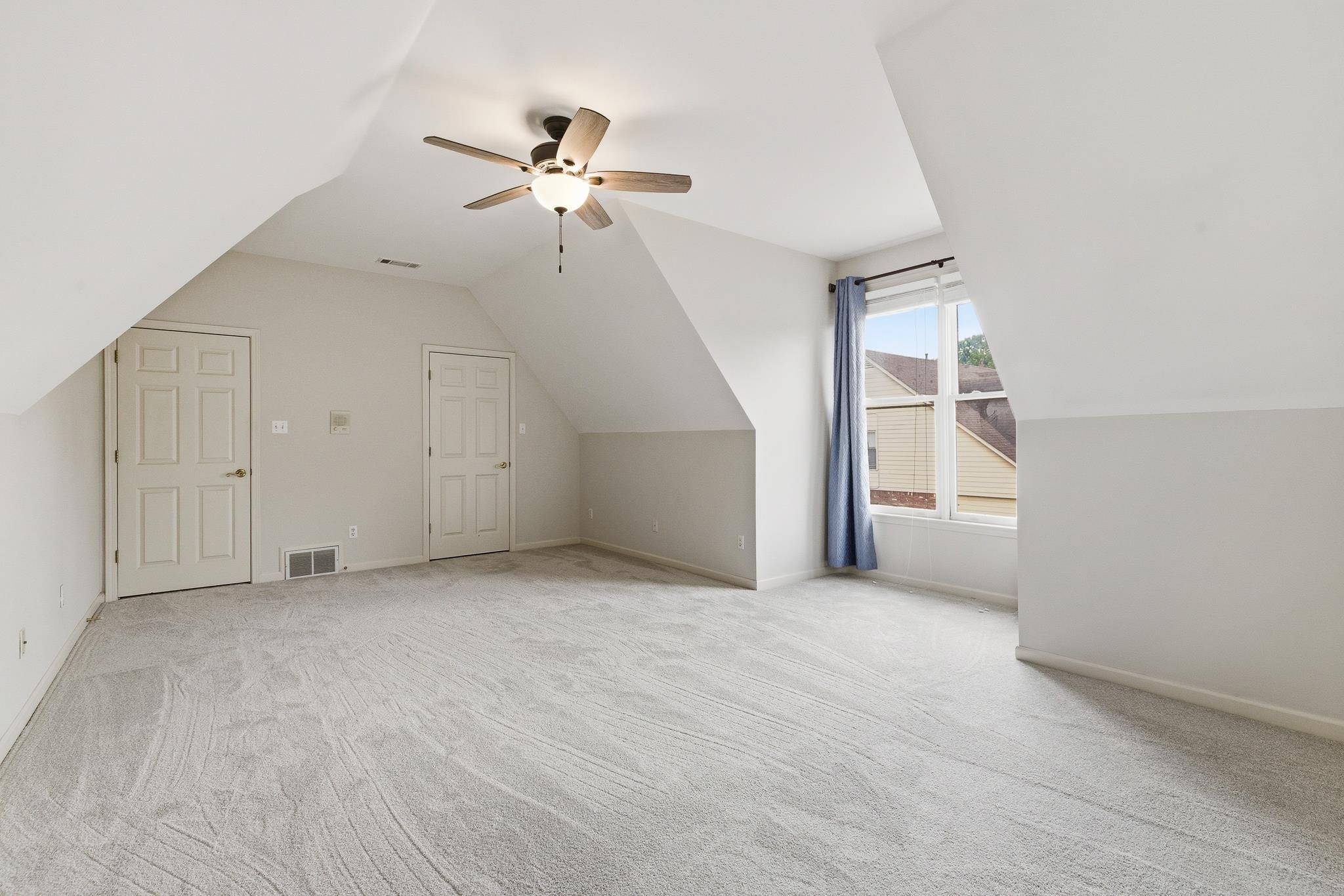 1348 Colbert Cove Collierville, TN 38017 - Photo 26 of 34 an empty room with chandelier fan and windows