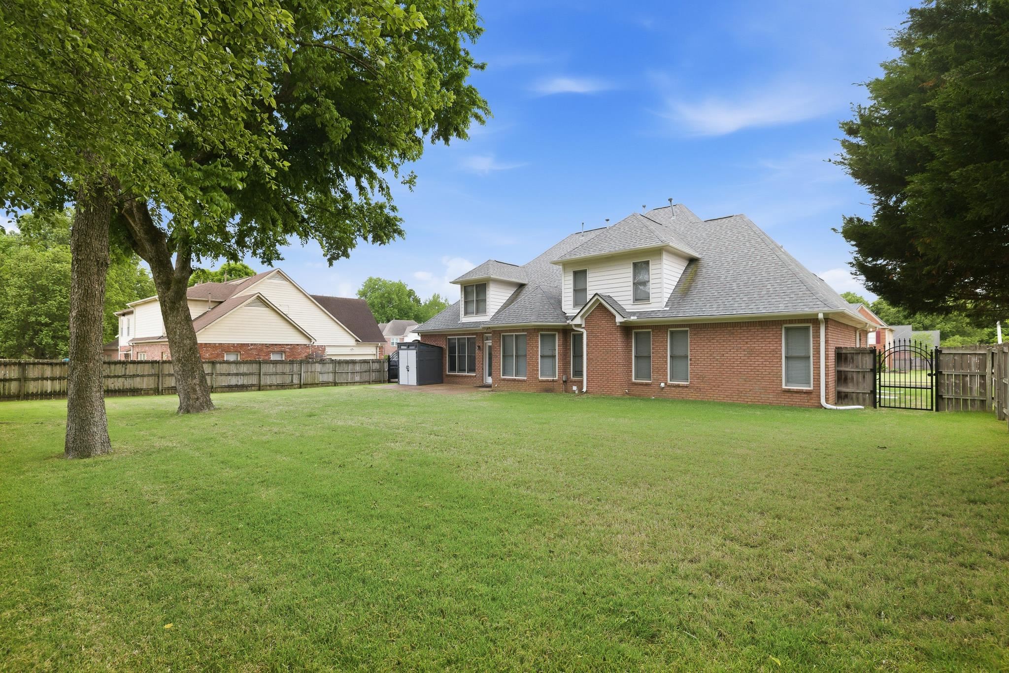 1348 Colbert Cove Collierville, TN 38017 - Photo 29 of 34 a front view of a house with a garden and trees