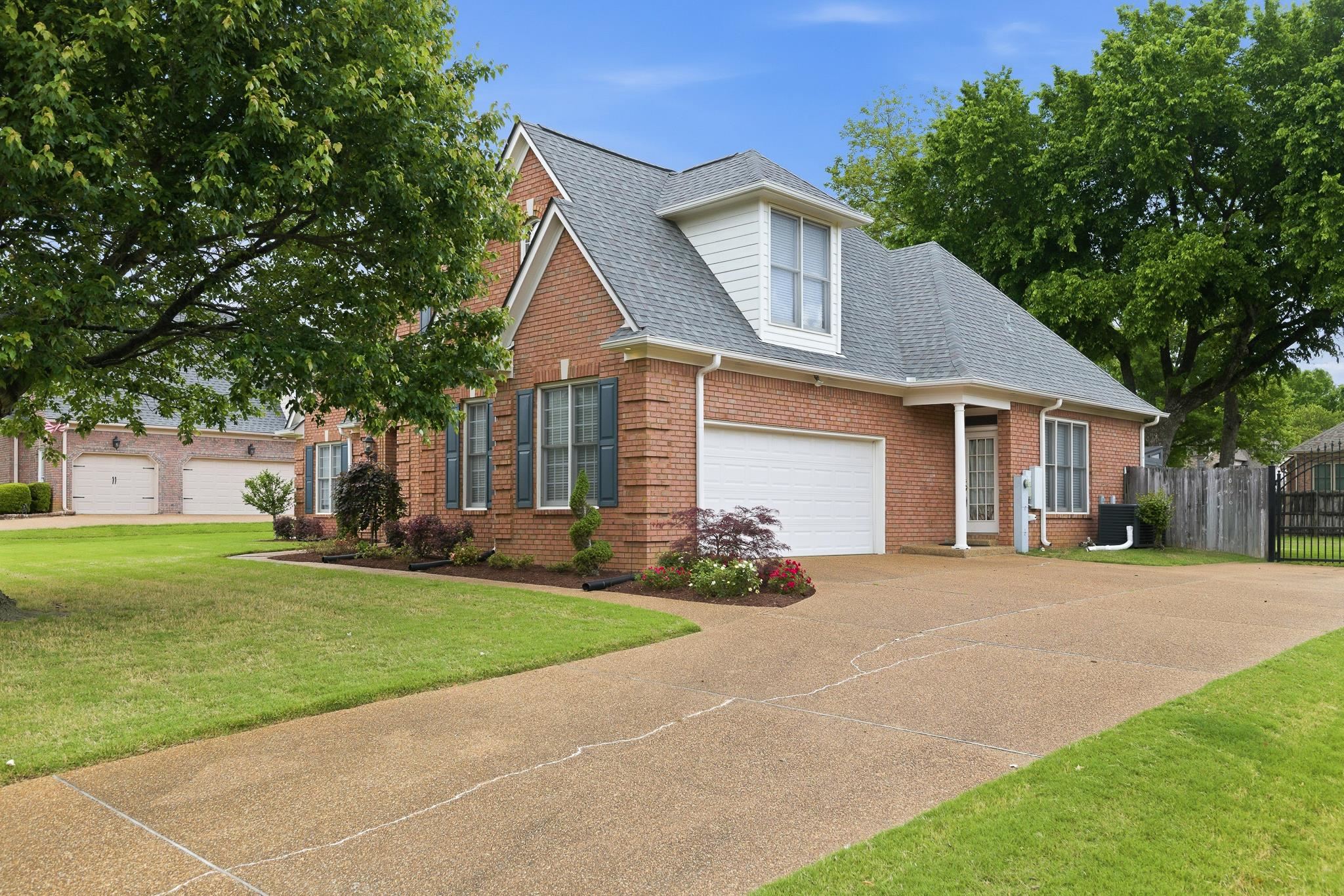 1348 Colbert Cove Collierville, TN 38017 - Photo 31 of 34 a front view of a house with a garden and trees