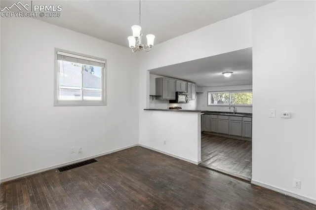 a view of a kitchen with a sink cabinets and wooden floor