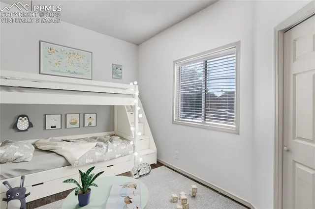 a view of a bedroom with bed and a window