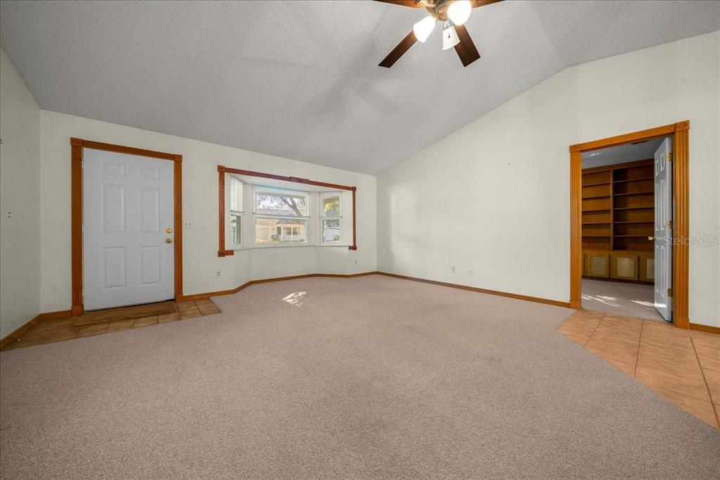 8431 Southwest 93rd Place, Unit A Ocala, FL 34481 - Photo 17 of 56 an empty room with windows and fan