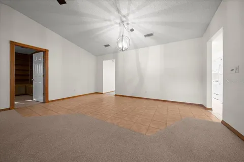 a view of an empty room with a ceiling fan