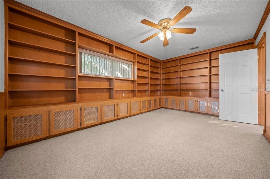 8431 Southwest 93rd Place, Unit A Ocala, FL 34481 - Photo 20 of 56 a view of an empty room with a ceiling fan