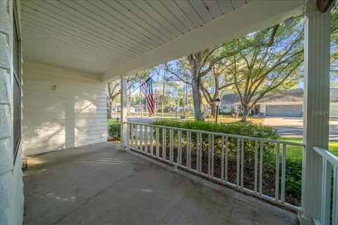 a view of a porch with wooden floor and fence