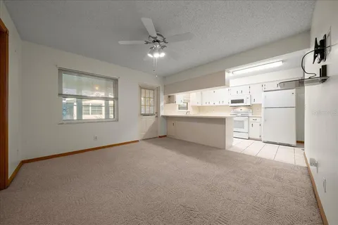 a kitchen with refrigerator a stove a microwave and white cabinets