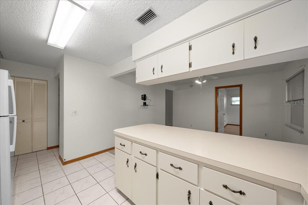 8431 Southwest 93rd Place, Unit A Ocala, FL 34481 - Photo 28 of 56 a bedroom with a bed and cabinets