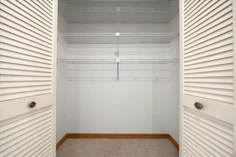 a bathroom with a sink a toilet a mirror and shower