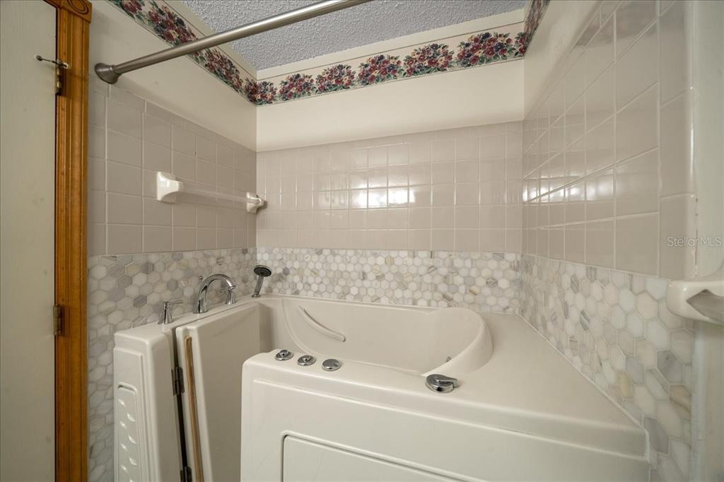 8431 Southwest 93rd Place, Unit A Ocala, FL 34481 - Photo 40 of 56 a bathroom with a bathtub and a shower