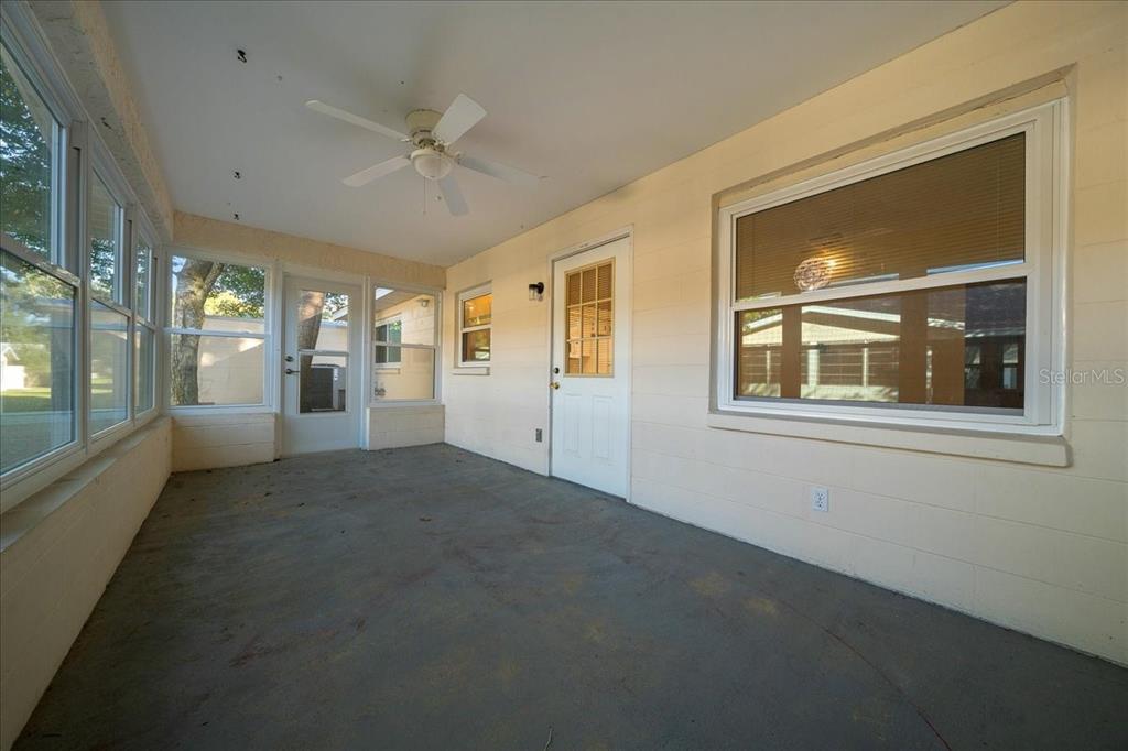 8431 Southwest 93rd Place, Unit A Ocala, FL 34481 - Photo 52 of 56 a view of a big room with windows and chandelier fan
