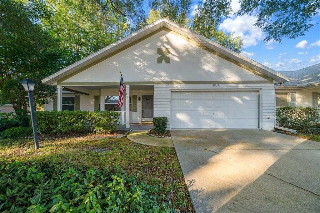 8431 Southwest 93rd Place, Unit A Ocala, FL 34481 - Photo 55 of 56 a view of a big house with yard and plants