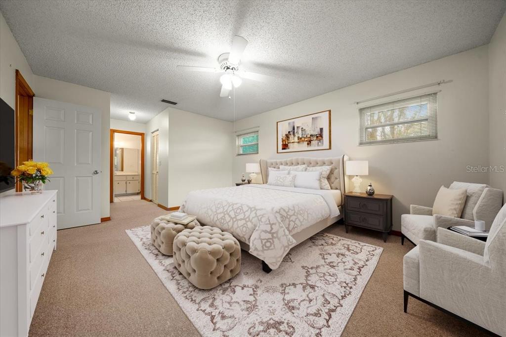 8431 Southwest 93rd Place, Unit A Ocala, FL 34481 - Photo 6 of 56 a bedroom with a large bed couch and a window