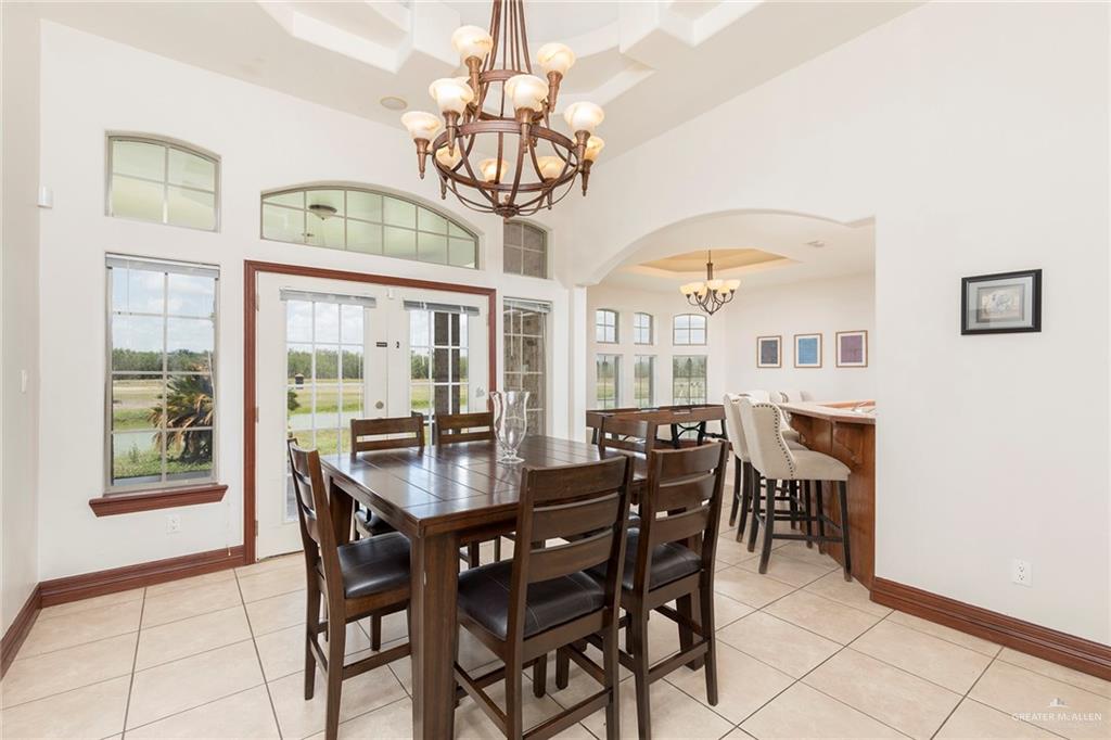 1213 Rhett Drive Pharr, TX 78577 - Photo 8 of 19 Bright dining area with soaring ceilings, elegant chandelier, and seamless flow to the kitchen.