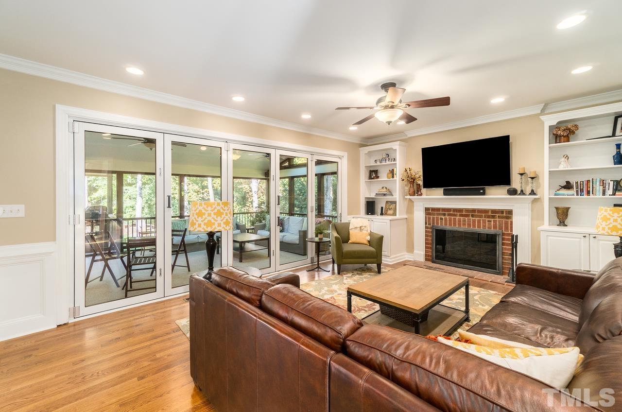9200 Ranworth Way Raleigh, NC 27615 - Photo 15 of 39 Family room includes a wood burning fireplace. Also equipped with bi-folding doors that lead directly to the screened in porch.