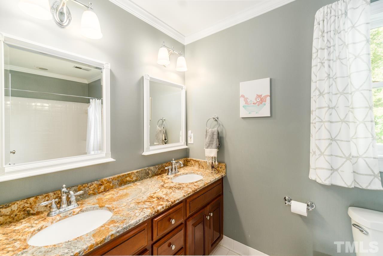 9200 Ranworth Way Raleigh, NC 27615 - Photo 23 of 39 Communal bathroom for bedrooms two and three on the second floor has a double vanity and a tub shower combo.