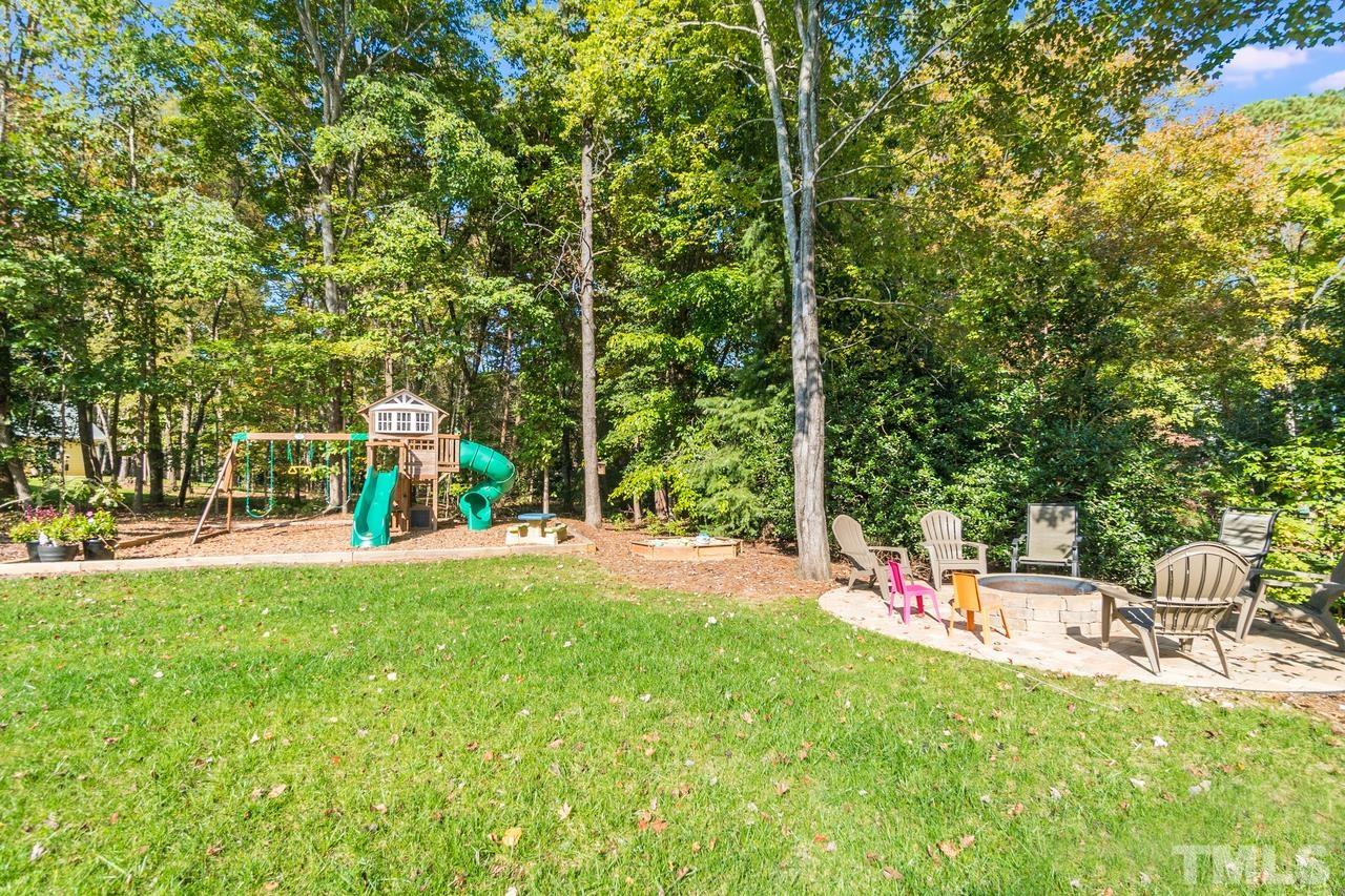 9200 Ranworth Way Raleigh, NC 27615 - Photo 33 of 39 Backyard features a fire pit.