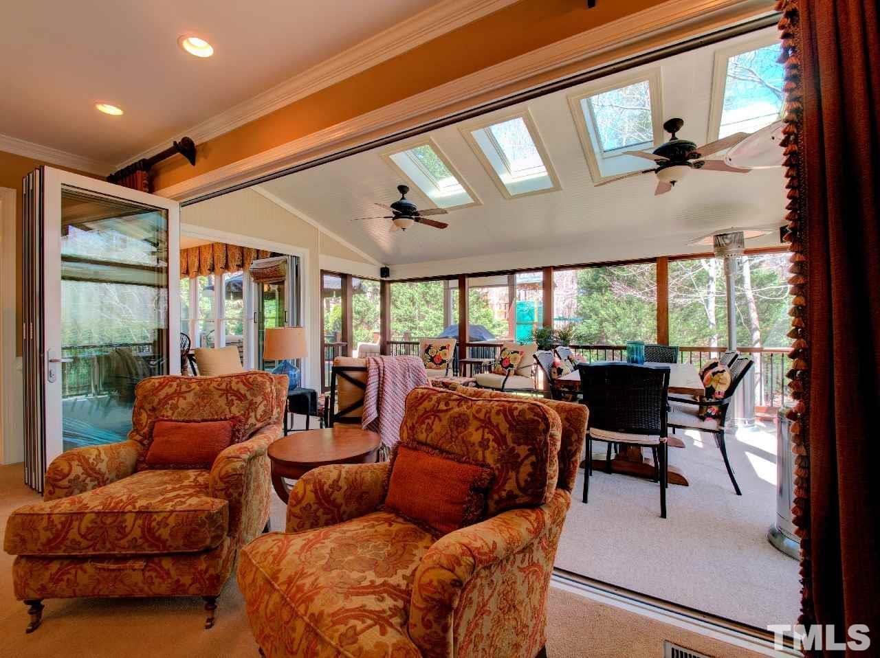 9200 Ranworth Way Raleigh, NC 27615 - Photo 37 of 39 Bi-folding sliding glass doors in the family room open to allow full access to the screened in porch.