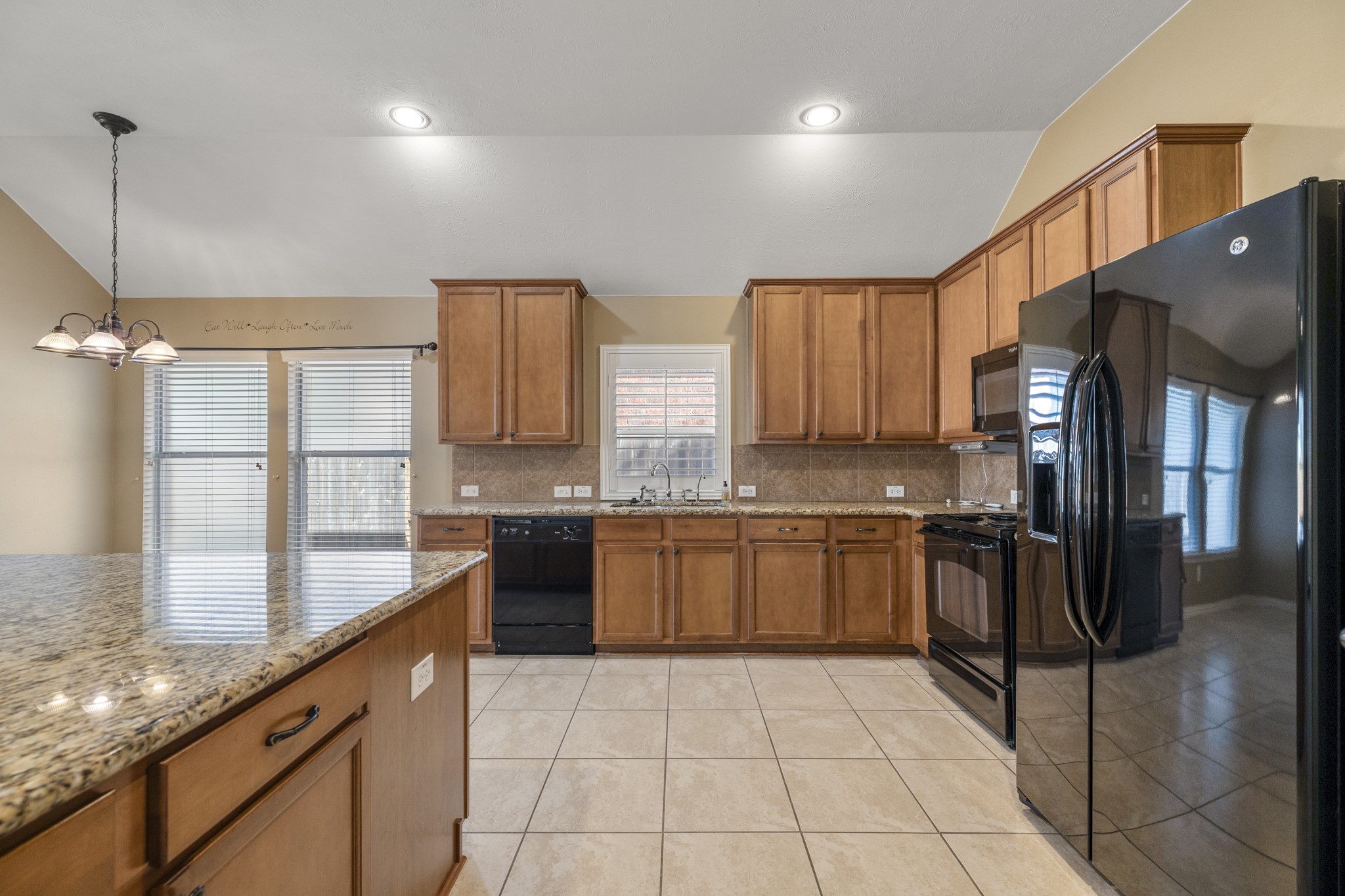 20014 Queens Oak Court Spring, TX 77379 - Photo 15 of 49 a kitchen with stainless steel appliances granite countertop a sink stove and refrigerator