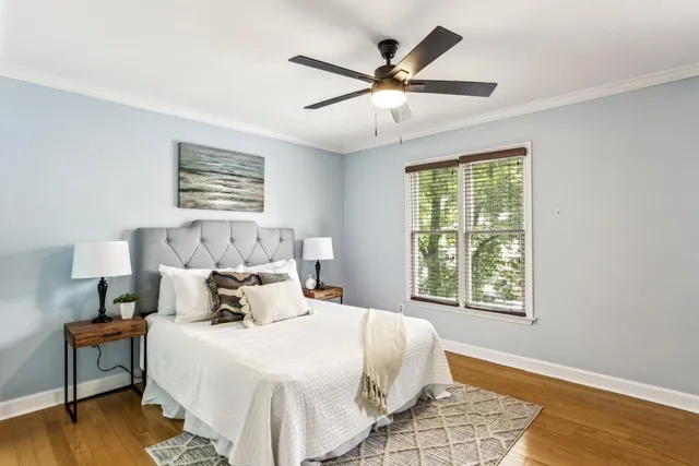 a bedroom with a large bed and a window