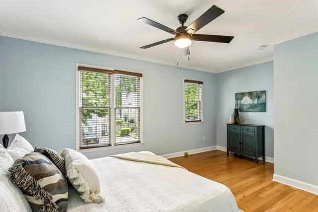 a bedroom with a bed a window and a chandelier