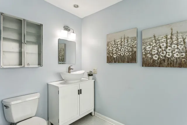 a bathroom with a toilet sink and mirror
