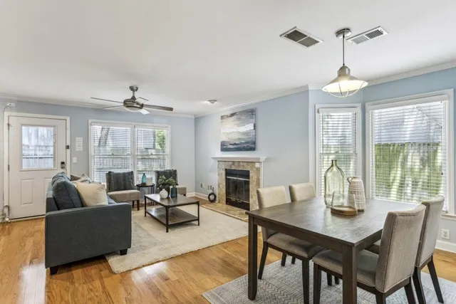 a living room with fireplace furniture and a large window