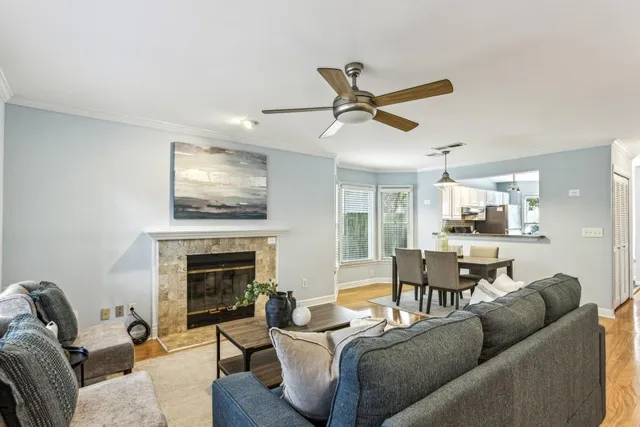 a living room with furniture kitchen view and a fireplace