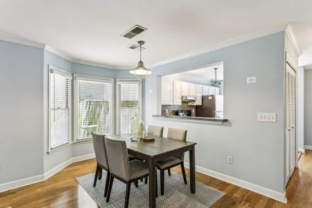 a view of a dining room with furniture window and wooden floor