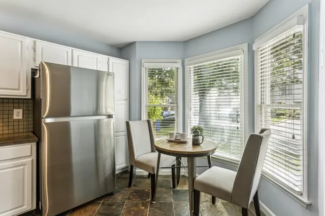 a view of a dining room with furniture window and outside view