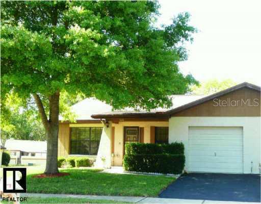 2126 Evans Road Dunedin, FL 34698 - Photo 1 of 1 a front view of a house with garden