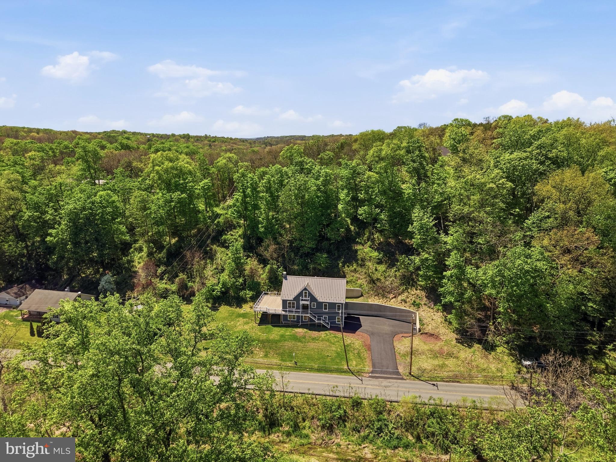 759 River Road Erwinna, PA 18920 - Photo 3 of 46 a view of a garden with plants and large trees